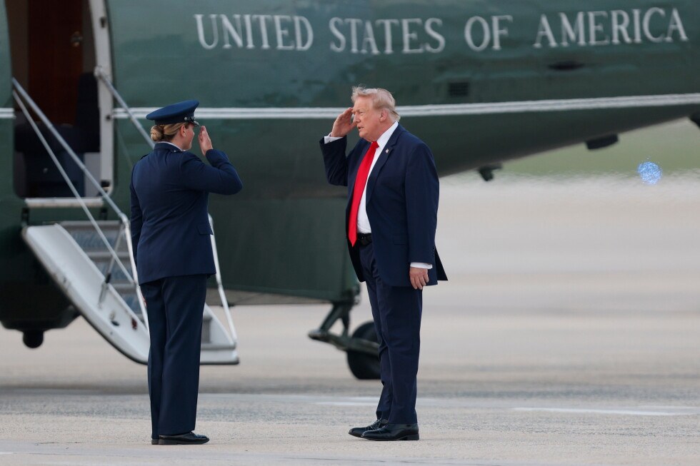 President Donald Trump, right, salutes Air Force 89th Air Wing Deputy Commander Melissa Dombrock, left, before boarding Marine One upon his arrival at Joint Base Andrews, Md., Sunday, July 19, 2026…
